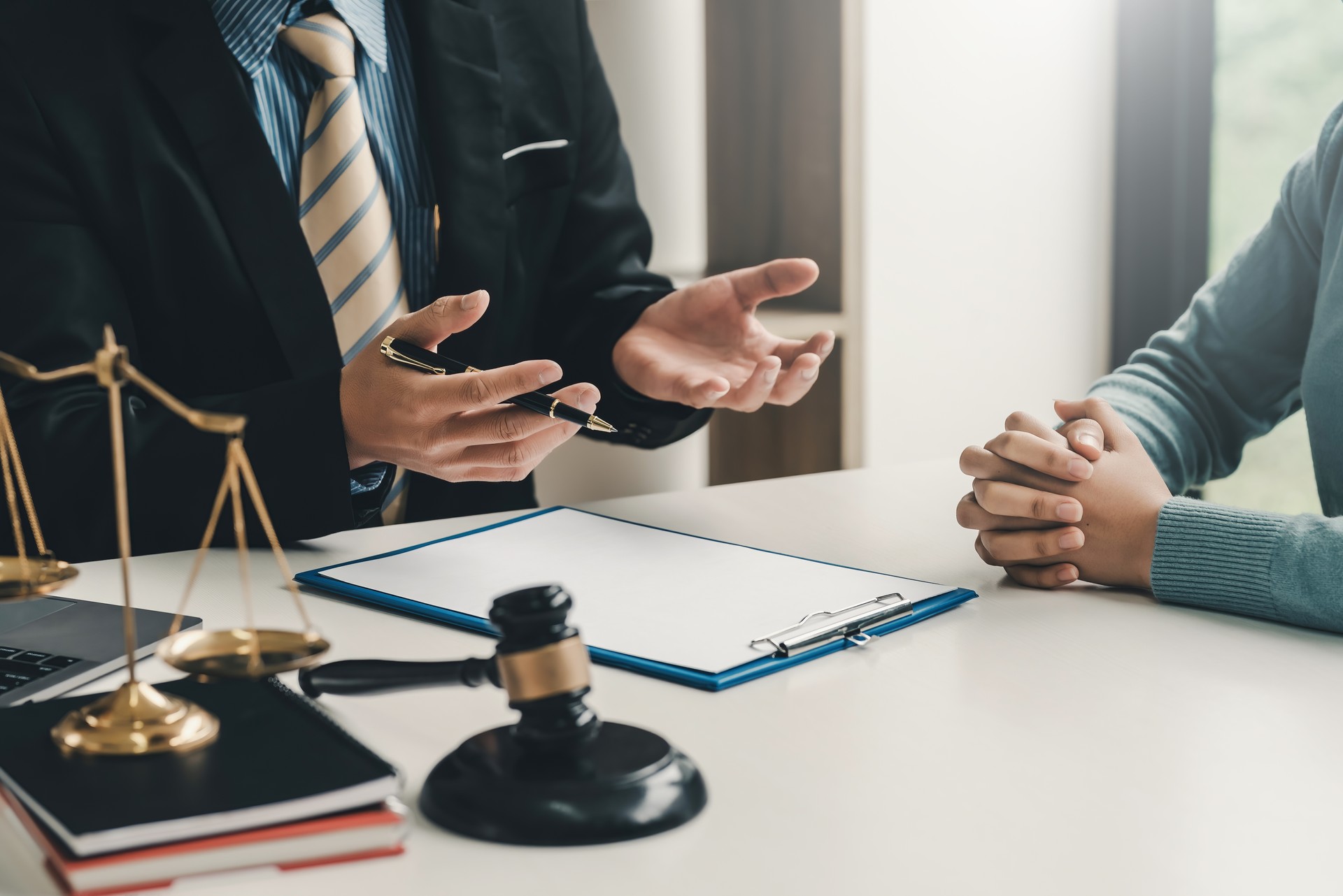 Image lawyer businessman sitting at the office with a woman customer explaining the agreement of advice. Image lawyer businessman sitting at the office with a woman customer explaining the agreement of advice.